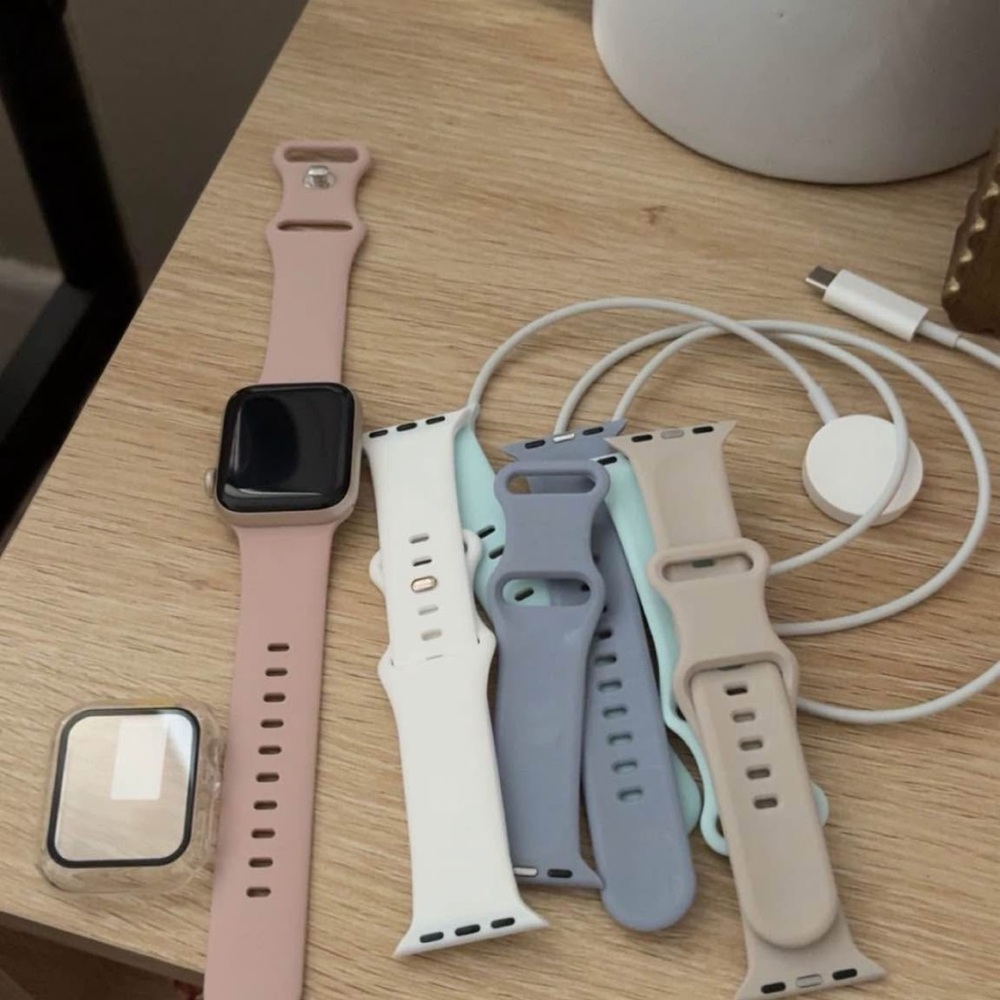 Apple Watch with Pink Band and Multiple Silicone Replacement Straps